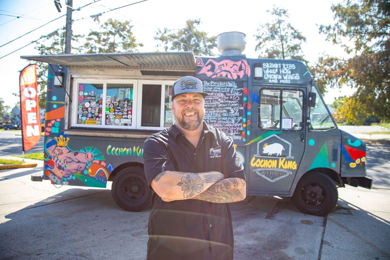 Standing in front of The Pig Truck, the Cochon King BBQ food truck